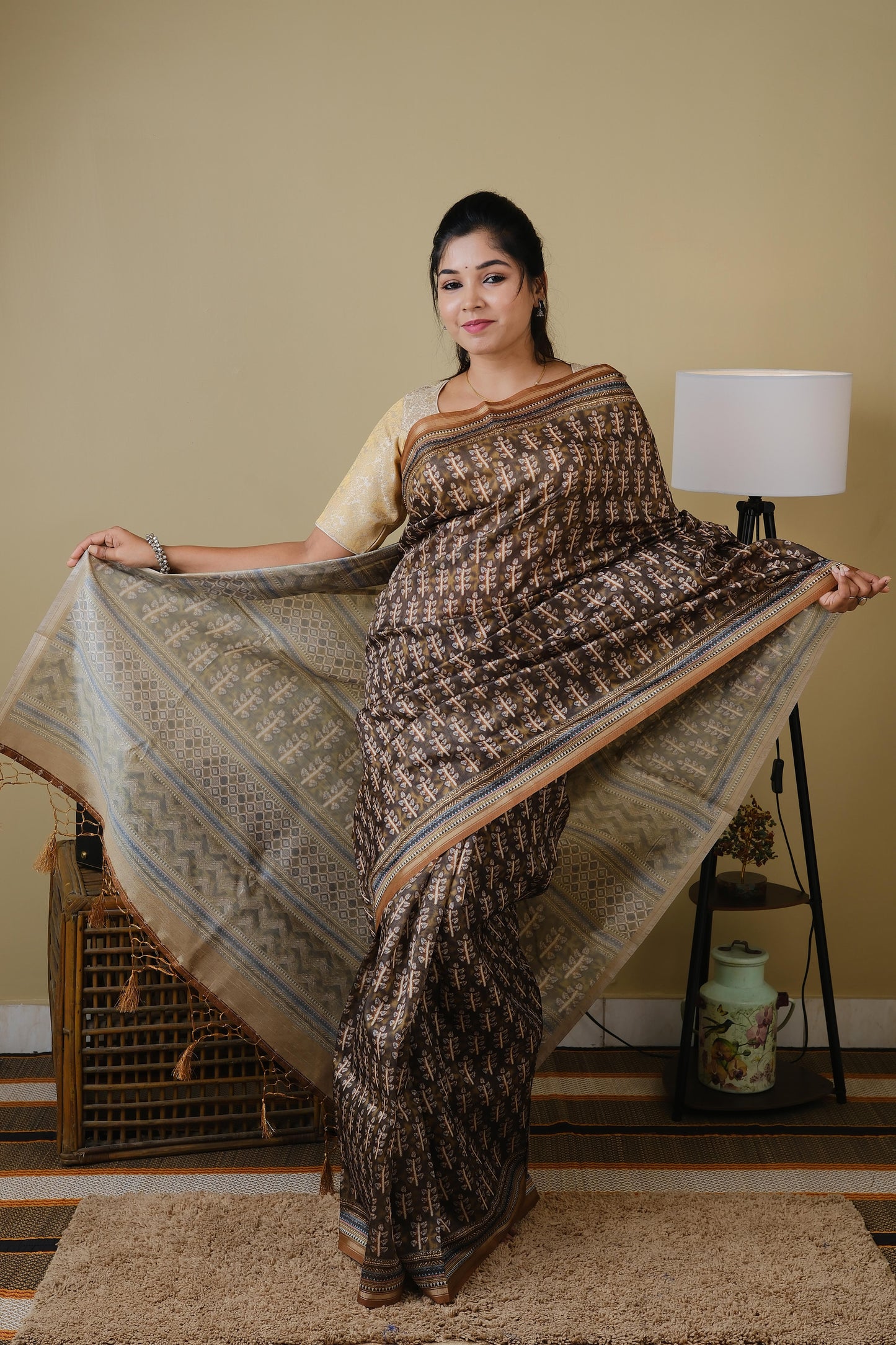 Synthetic organza in olive brown with all over ethnic prints and simple zari border - BOOMIKA