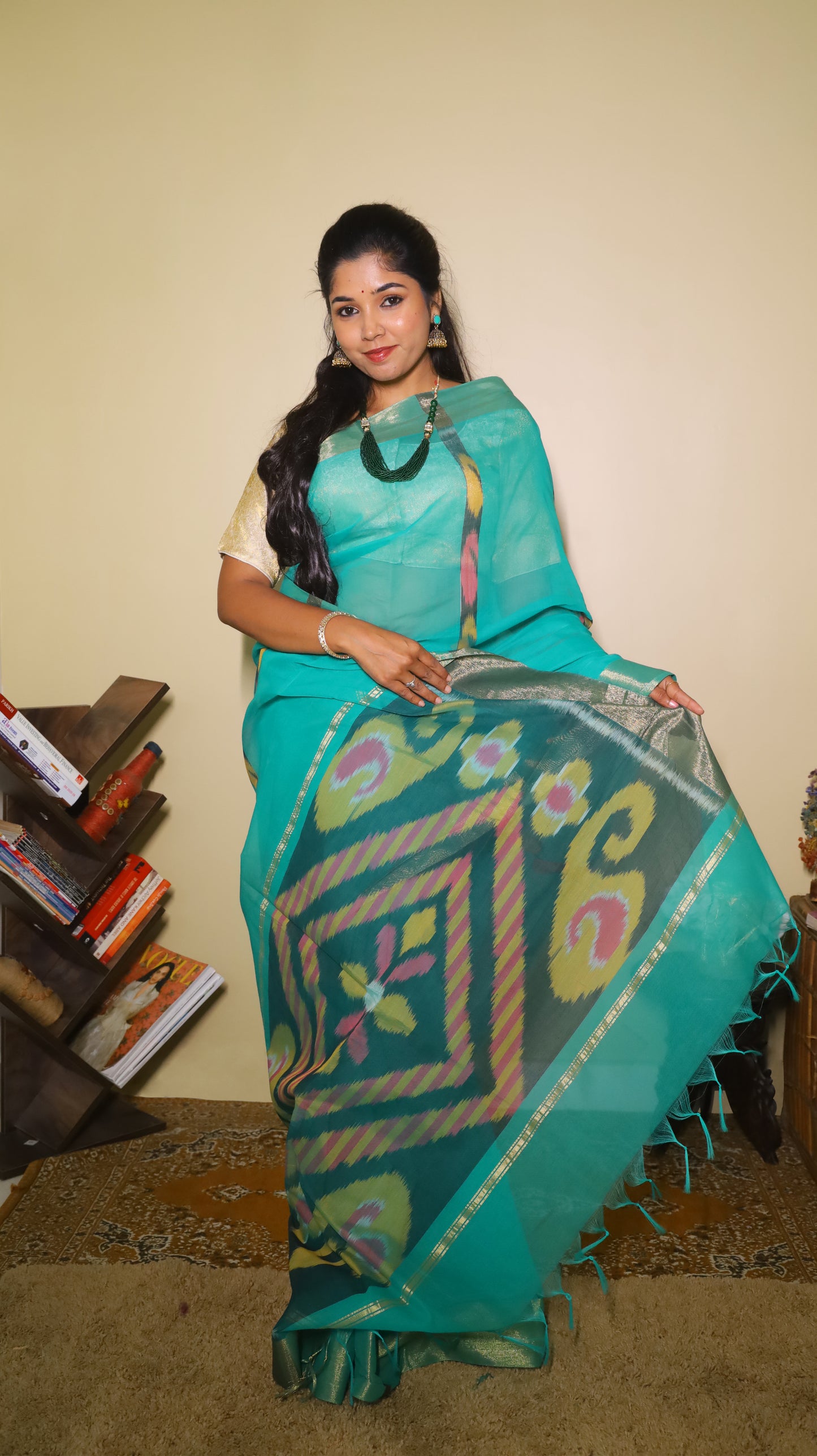 Breathable green silk cotton saree featuring bold Ikat-inspired geometric patterns with tasseled pallu - VEDHIKA