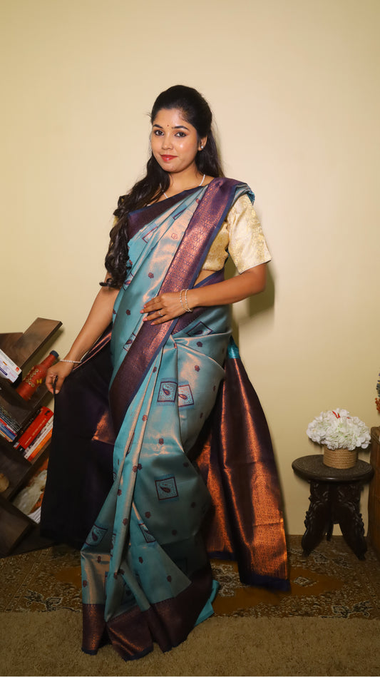 Classic soft silk tissue saree in light aqua blue body with rust-colored motifs and turquoise border along with copper-gold zari - AVANTHIKA