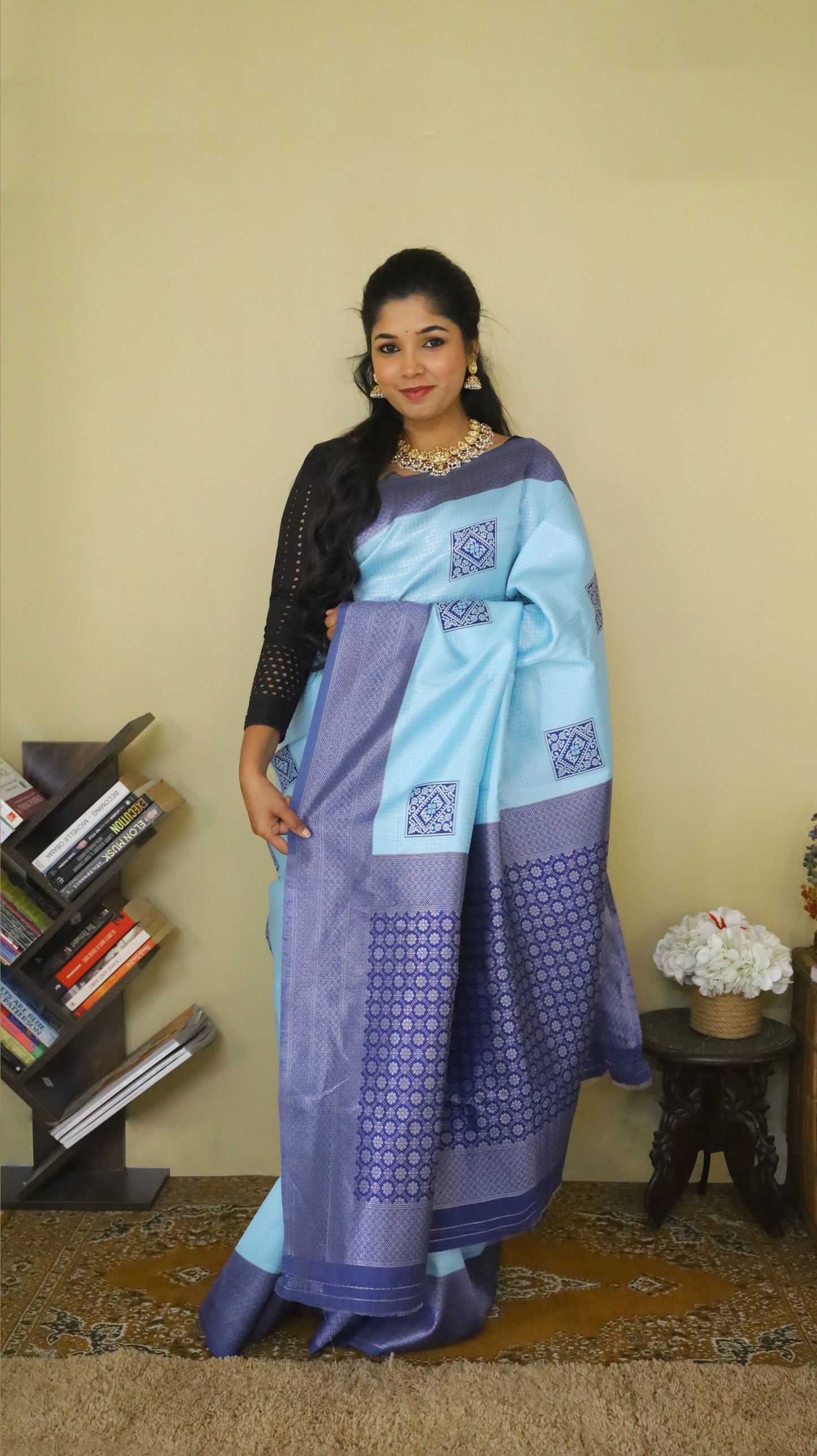 Graceful Soft Silk Saree with a soft light blue body, adorned with delicate buttas, and complemented by a bold dark blue border and pallu - AVANTHIKA