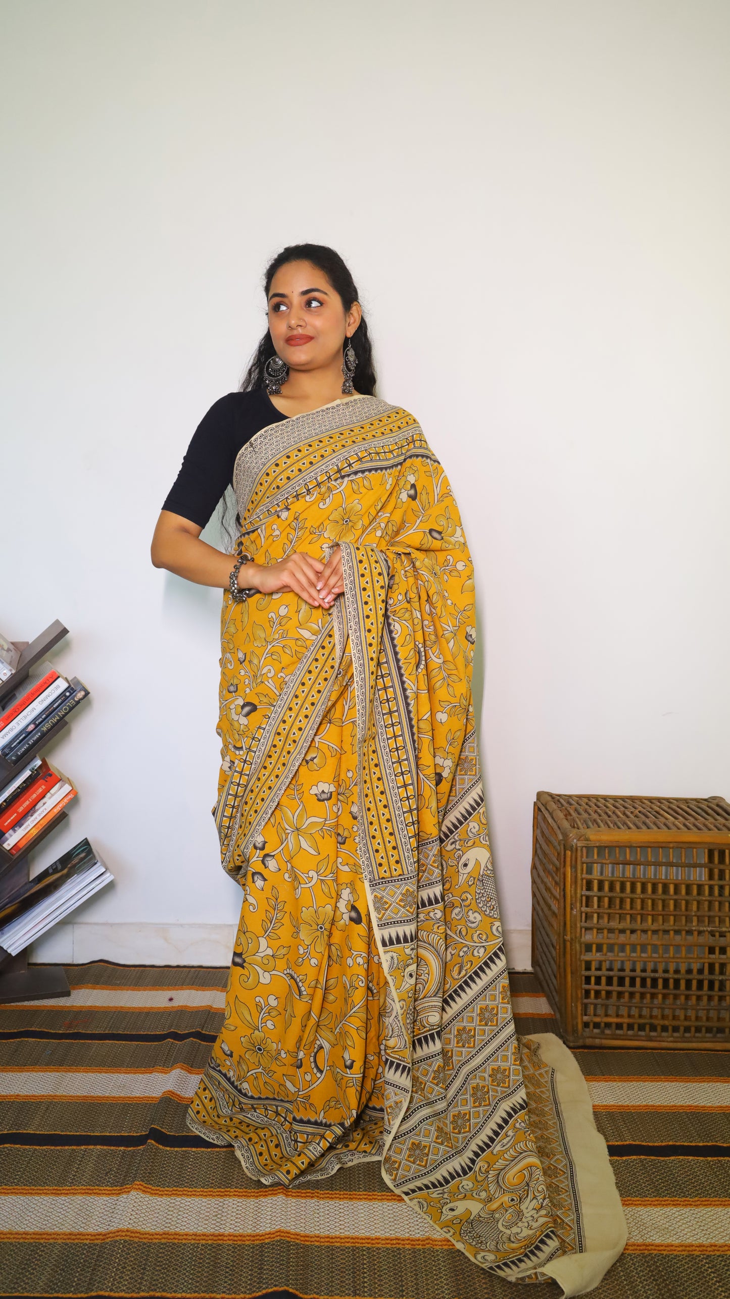 Vibrant mustard yellow soft cotton kalamkari saree featuring flowers and peacocks in light grey and black - BOOMIKA