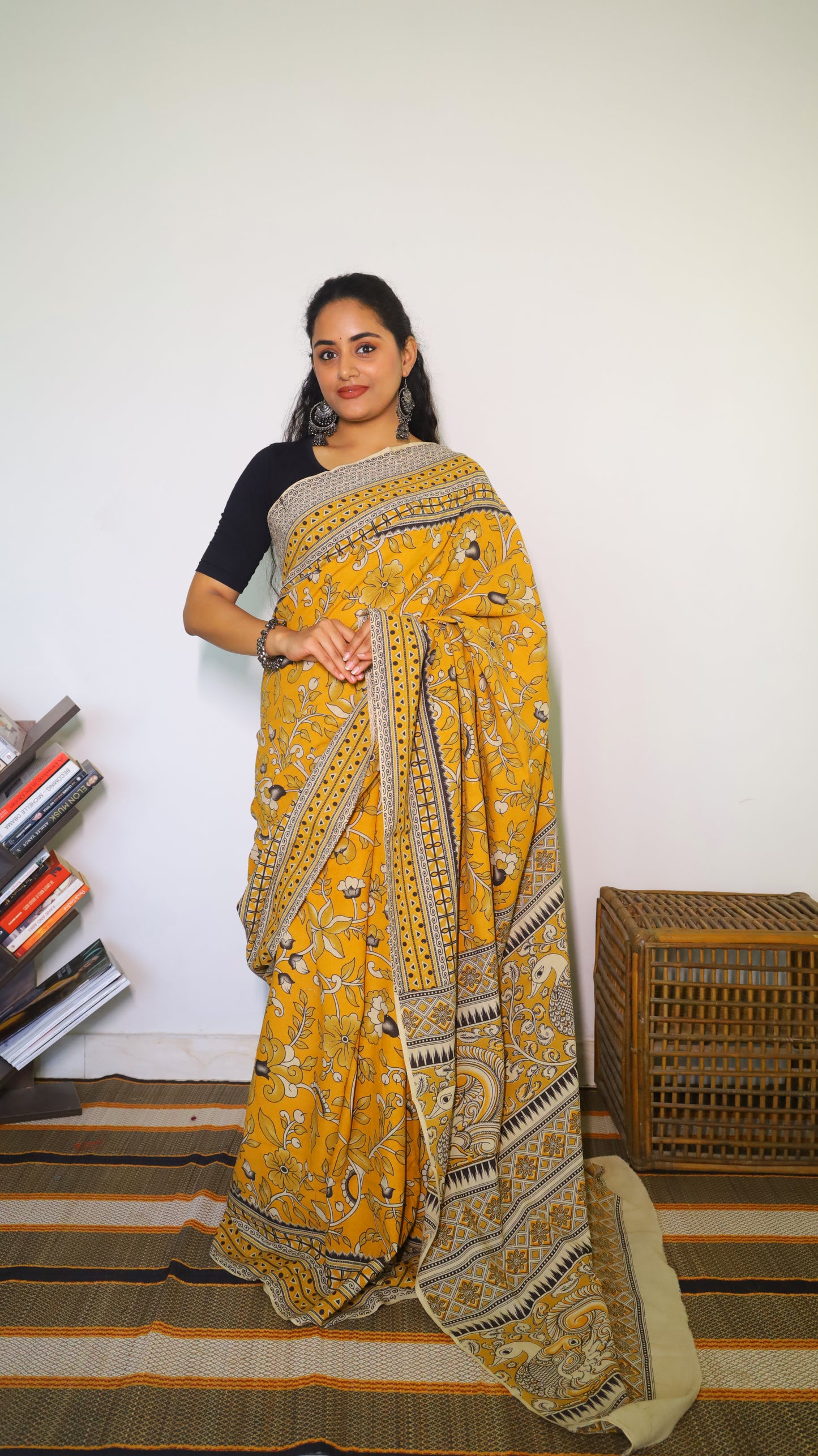 Vibrant mustard yellow soft cotton kalamkari saree featuring flowers and peacocks in light grey and black - BOOMIKA