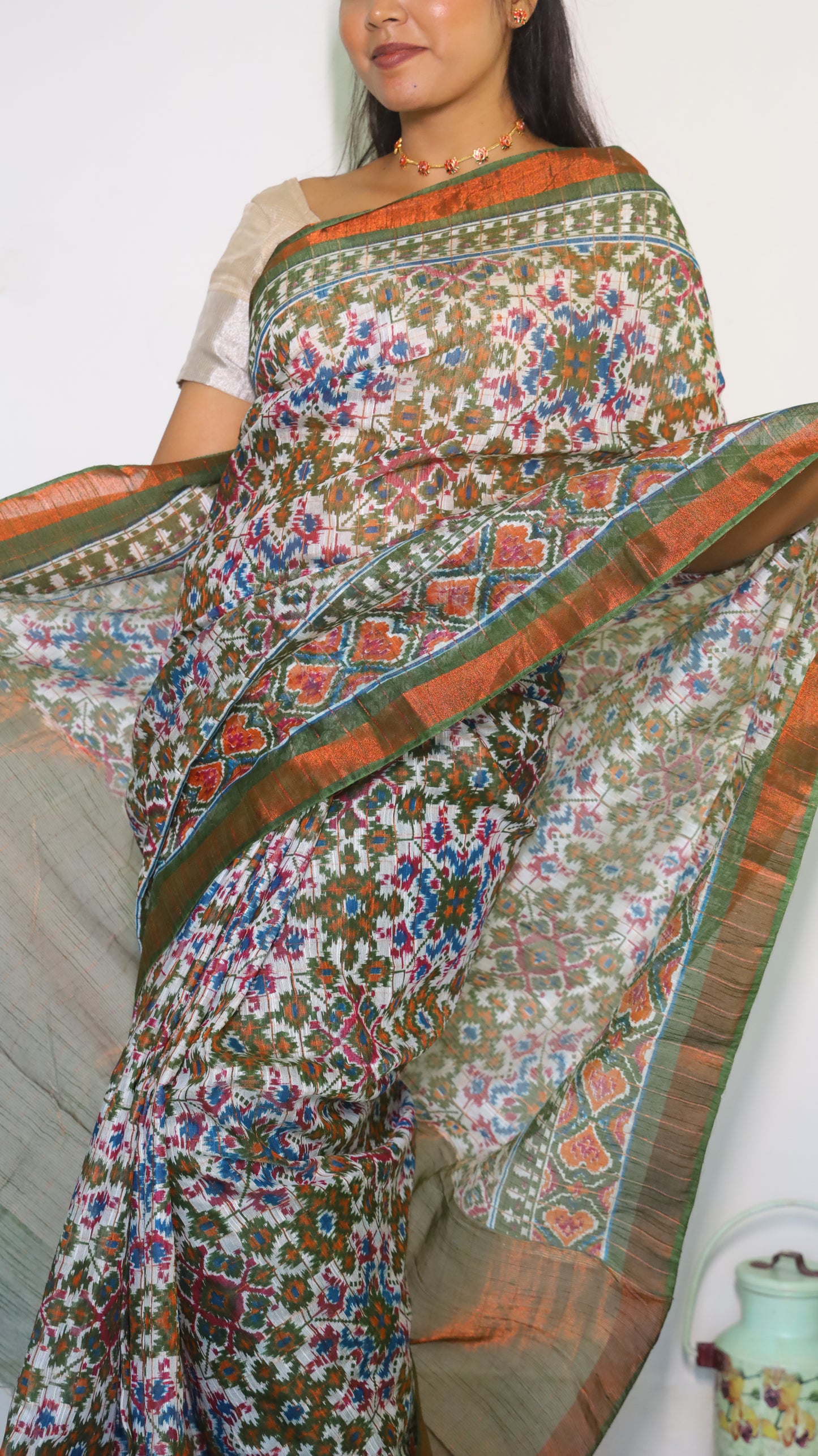 Graceful Semi Silk Cotton Saree in white and adorned with exquisite Patola prints - VEDHIKA