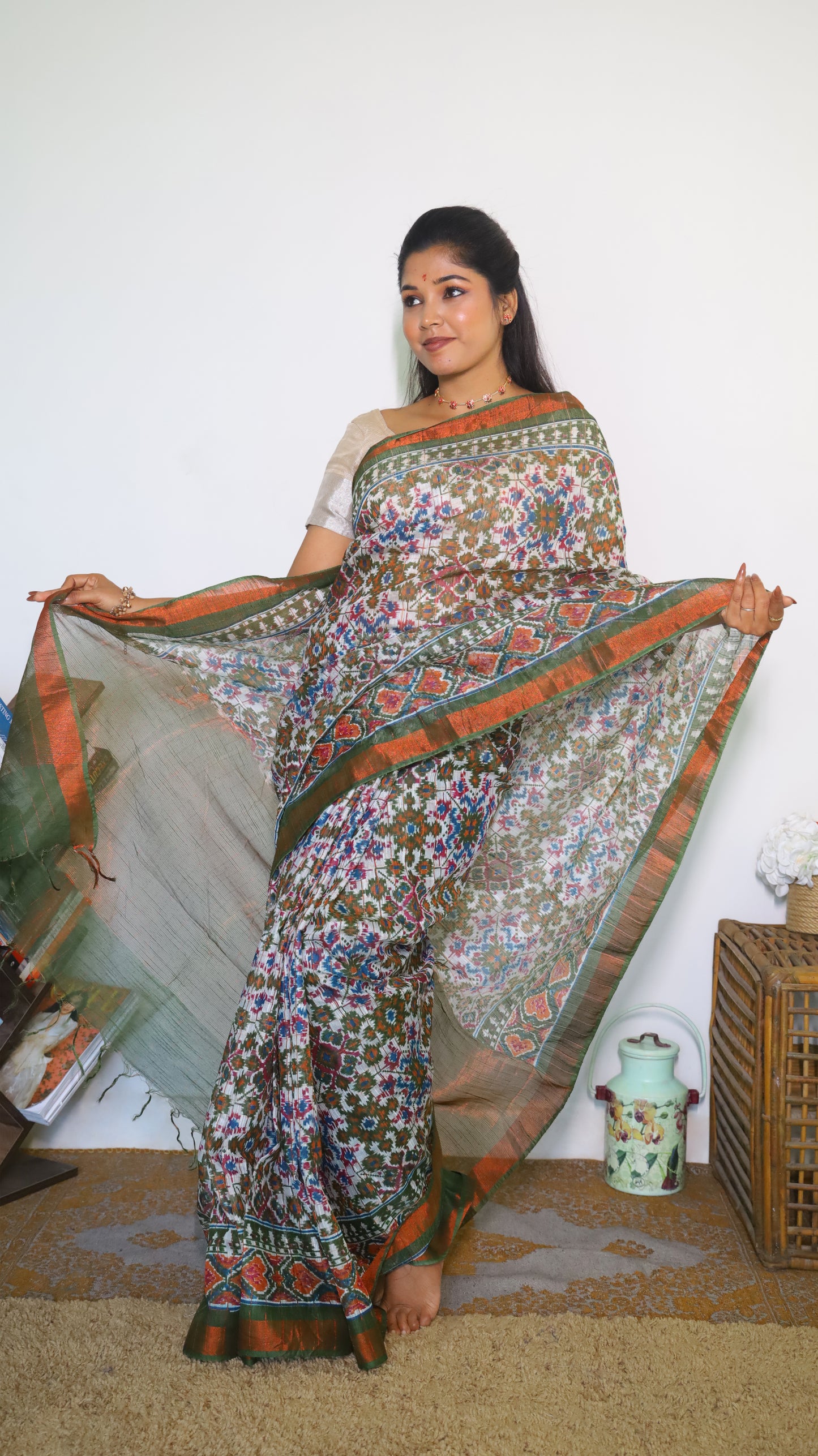 Graceful Semi Silk Cotton Saree in white and adorned with exquisite Patola prints - VEDHIKA