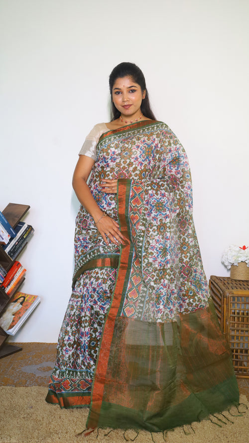 Graceful Semi Silk Cotton Saree in white and adorned with exquisite Patola prints - VEDHIKA