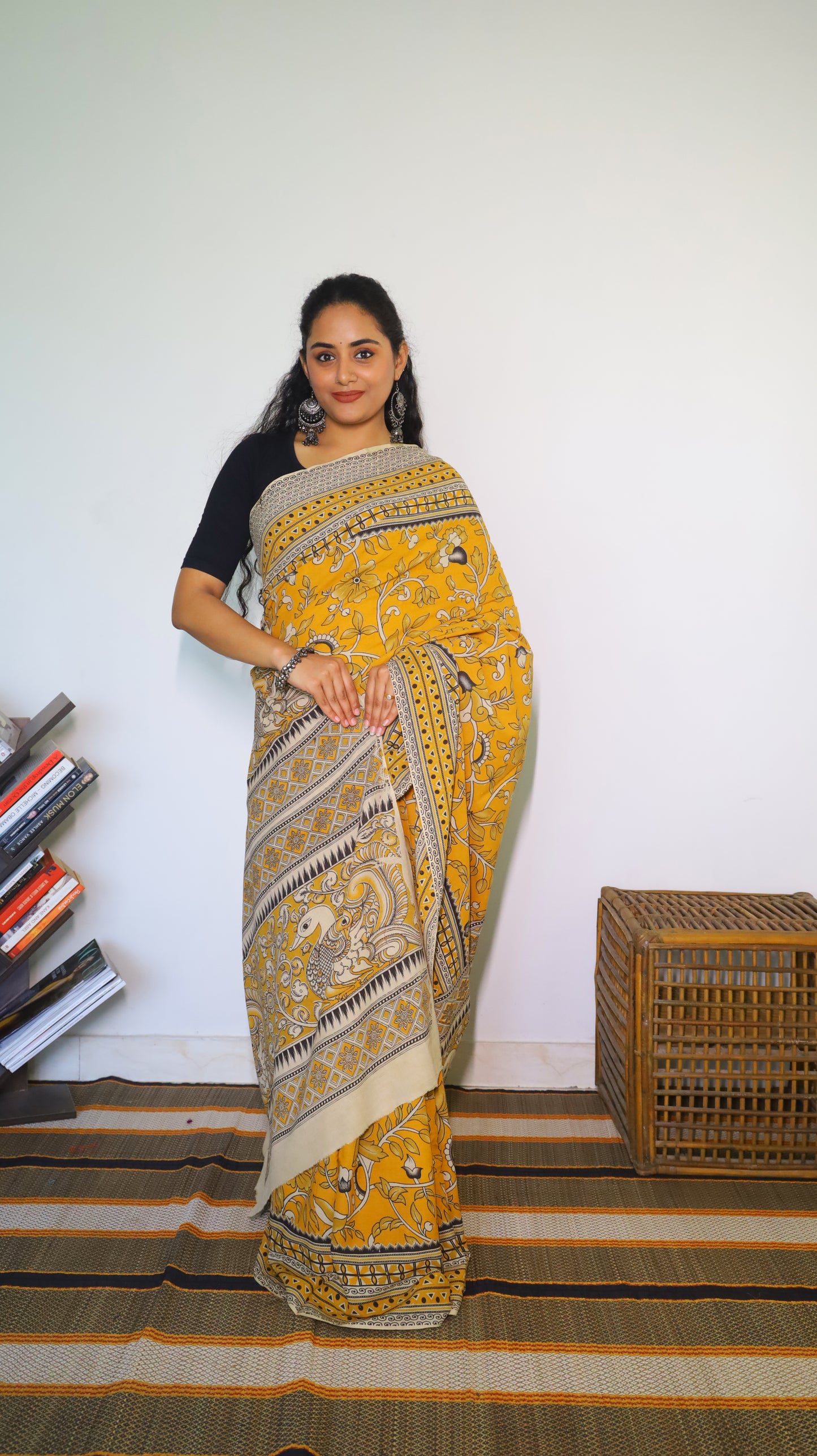 Vibrant mustard yellow soft cotton kalamkari saree featuring flowers and peacocks in light grey and black - BOOMIKA