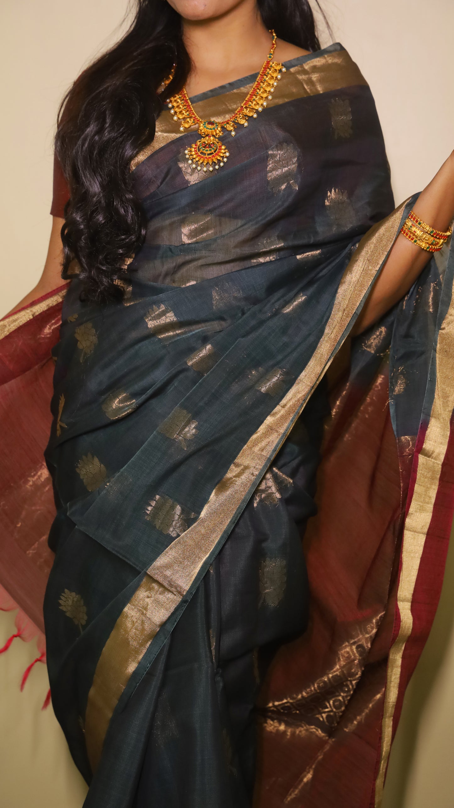 Exquisite silk cotton saree in bottle green and reddish maroon, handwoven with intricate designs - SWASTHIKA