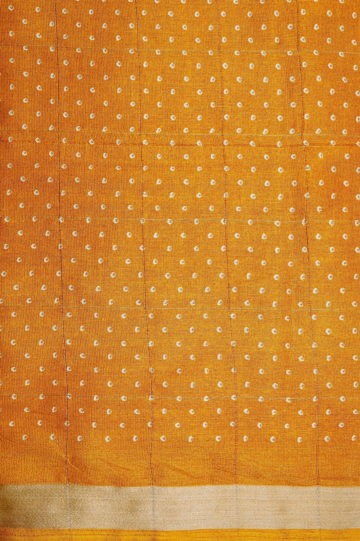 Turmeric gold semi silk saree with its intricate white dotted body, perfect for casual wear - SHRUTHIKA
